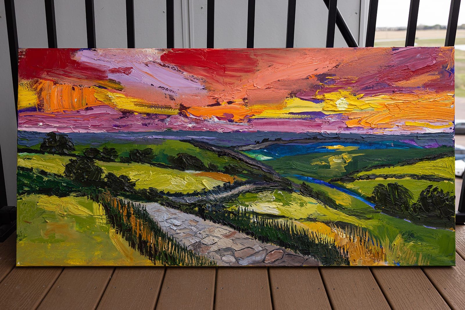 Sunset, the whole canvas, leaning against a deck railing
